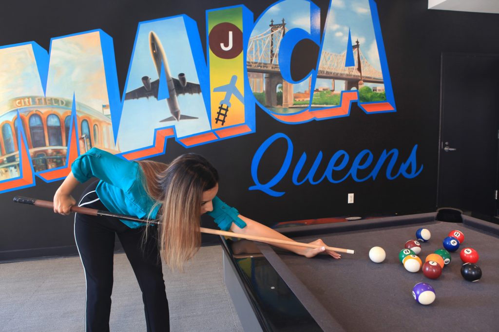Woman playing pool in the lounge